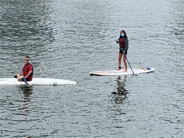 Nayeli paddleboarding with a client
