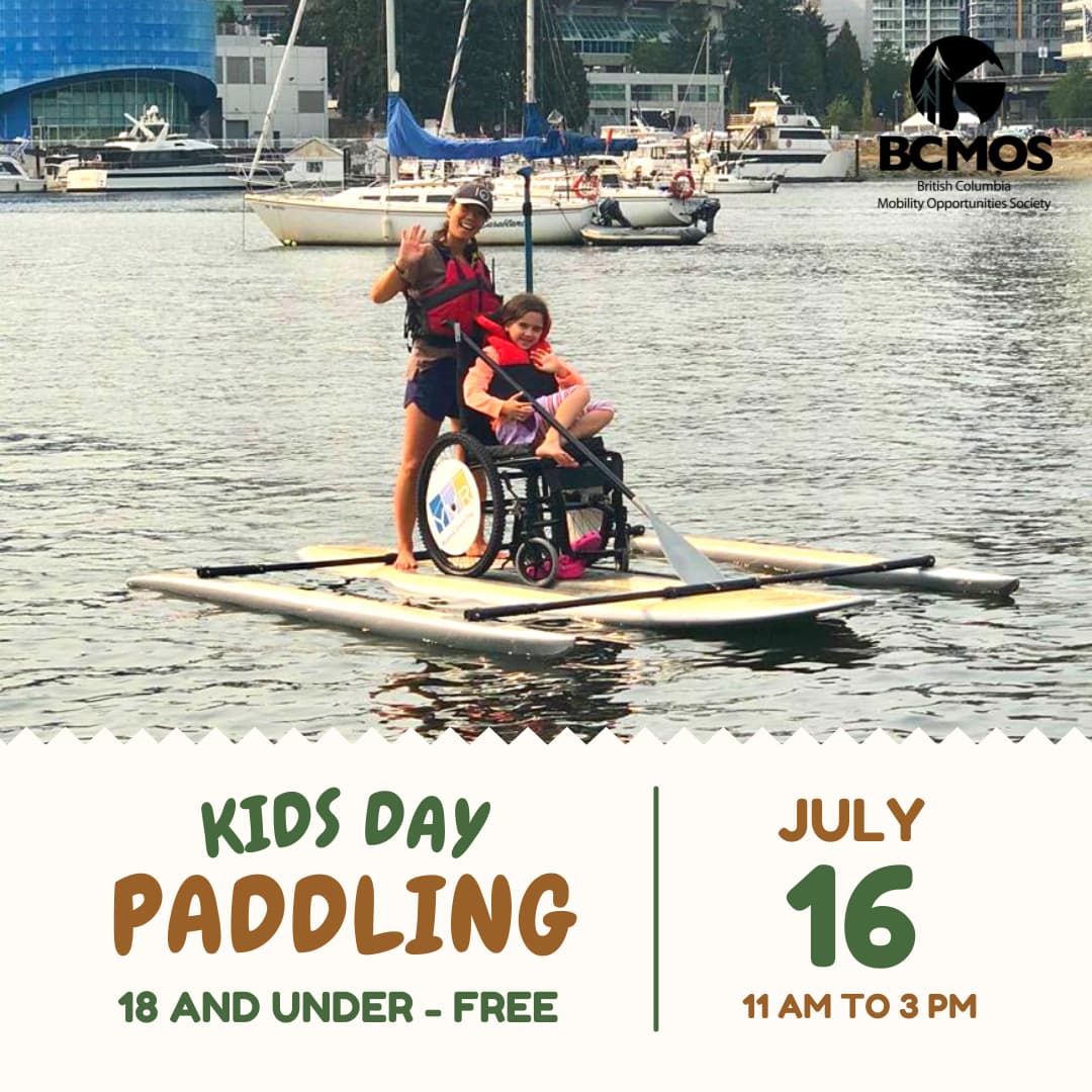 Volunteer and child using accessible paddle board. (Kids Day Paddling, 18 and under free. July 16th, 11 am to 3 pm.)
