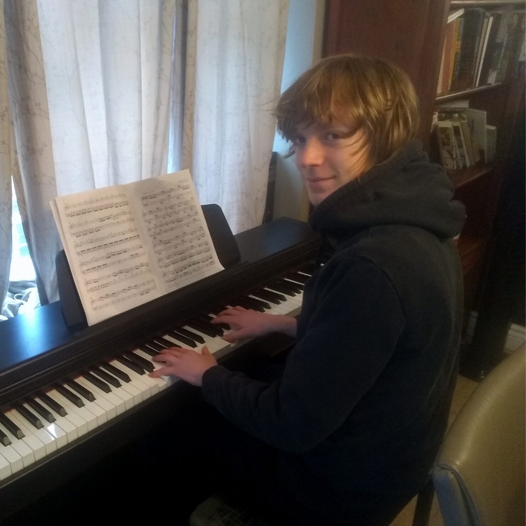 Theo playing the piano
