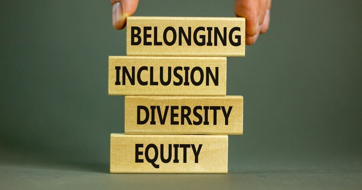 Words: belonging, inclusion, diversity, equity on wooden blocks.