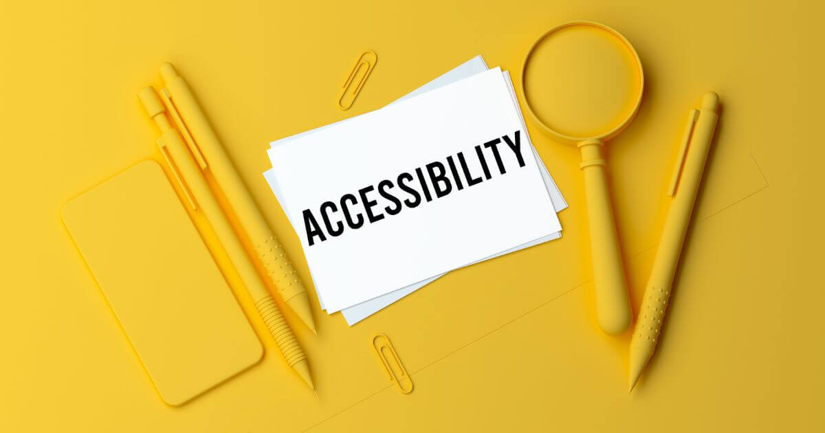 A note with the word “accessibility” , a magnifier, and a pen.