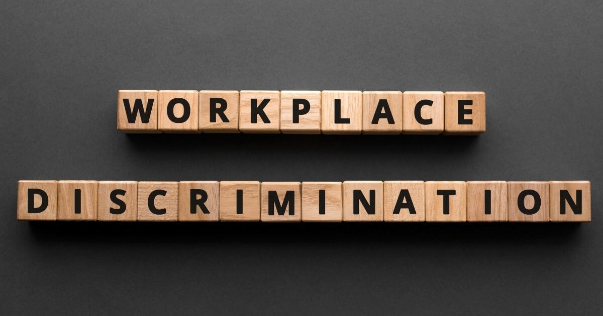 "Workplace discrimination", words from wooden blocks with letters.